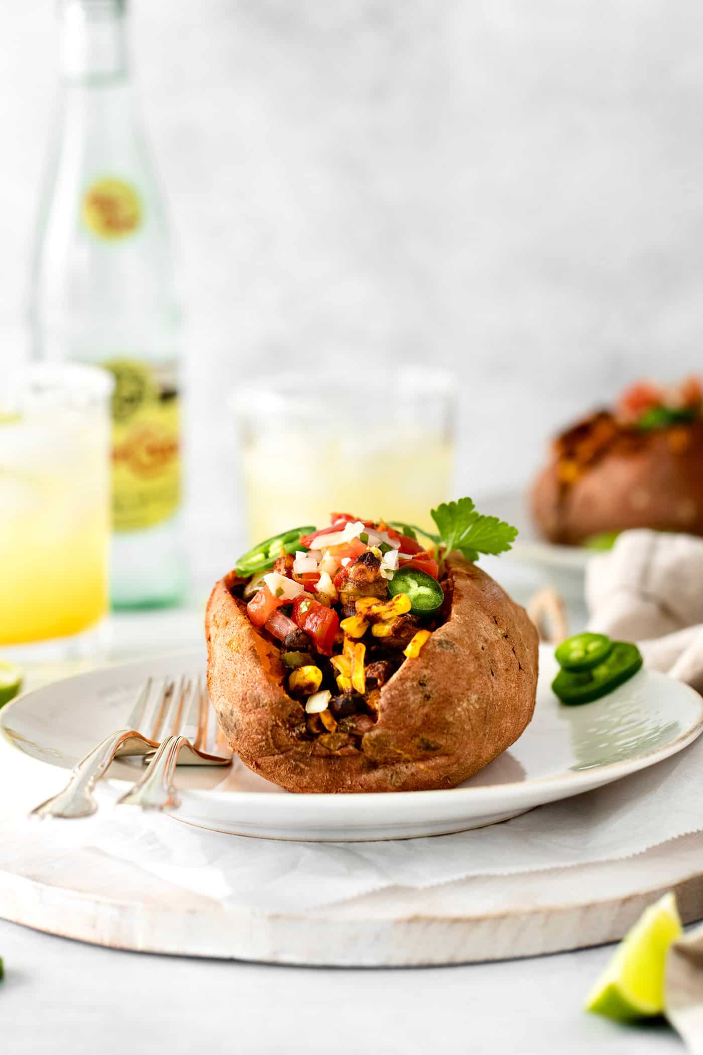 Front view of a stuffed sweet potato on a white plate