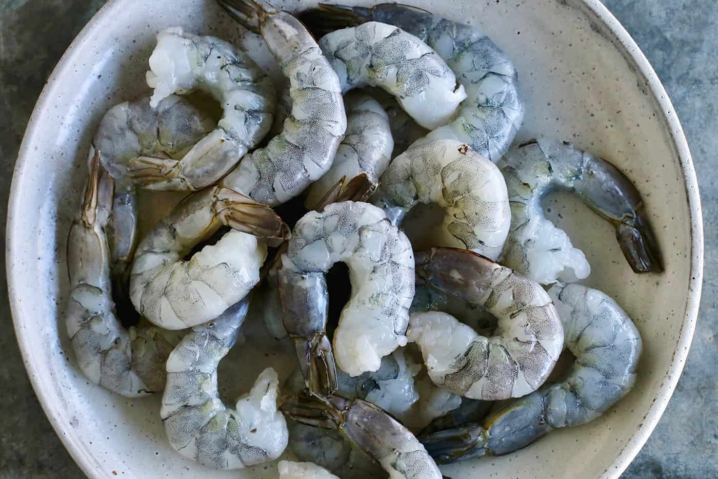 Raw shrimp in a white bowl