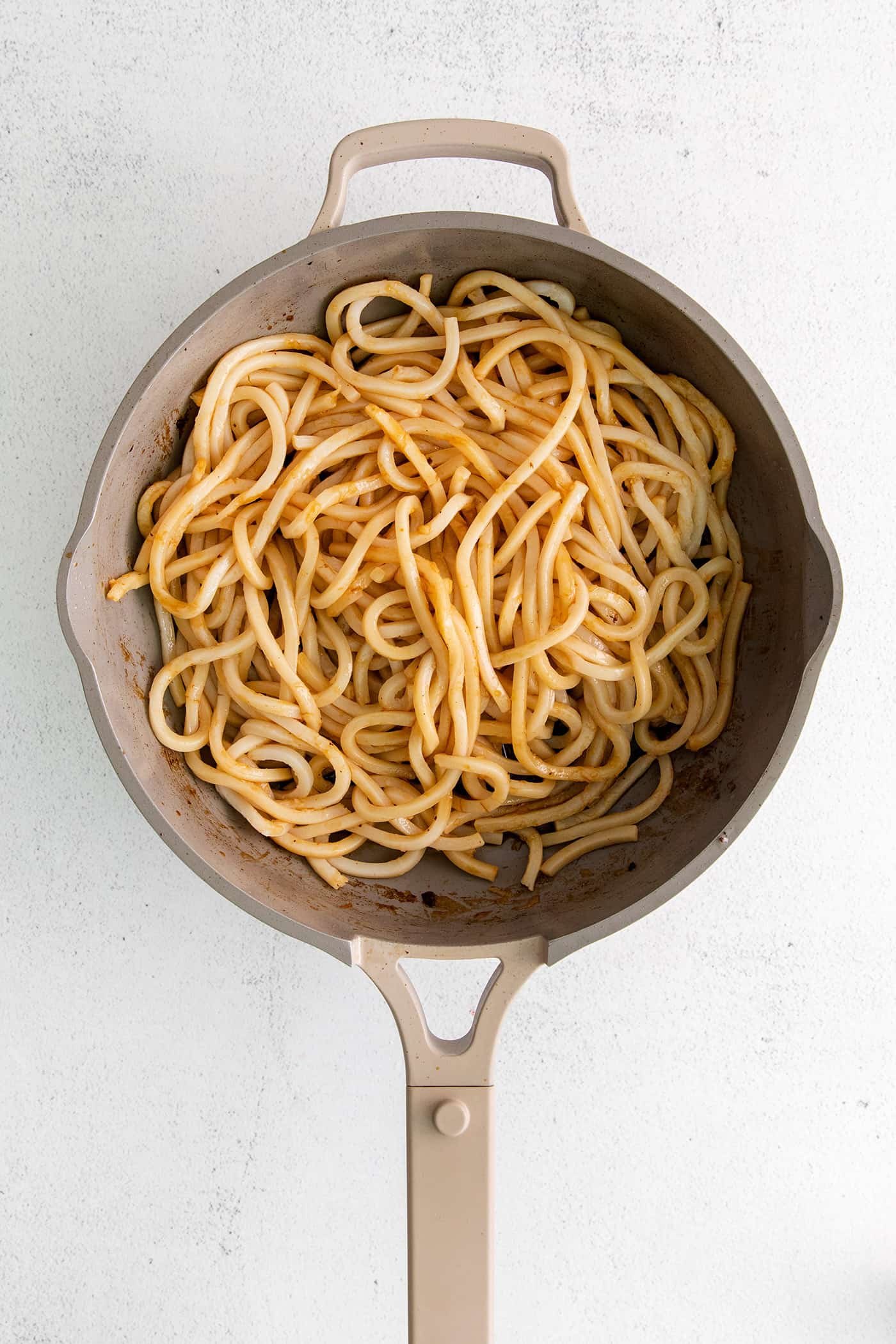 Overhead view of udon noodles in a skillet