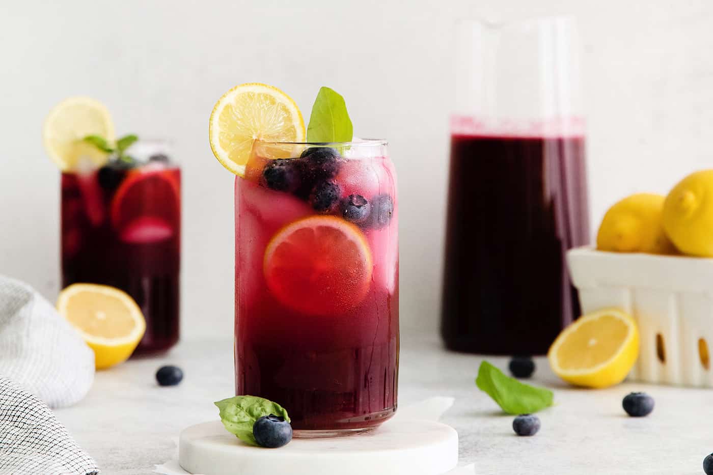 Two glasses of blueberry basil lemonade