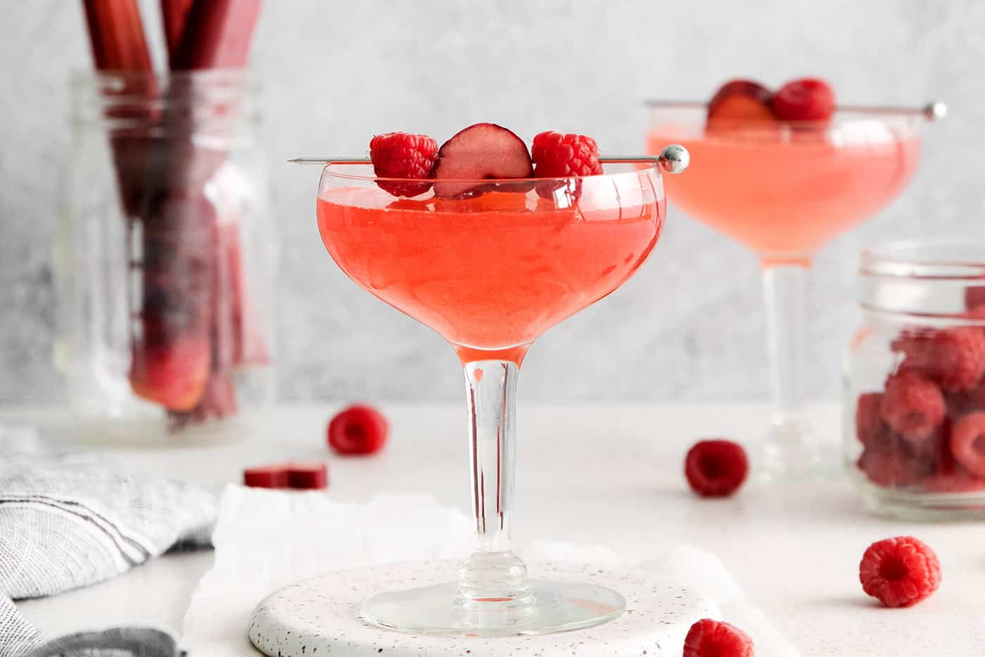 Two rhubarb raspberry cosmopolitans