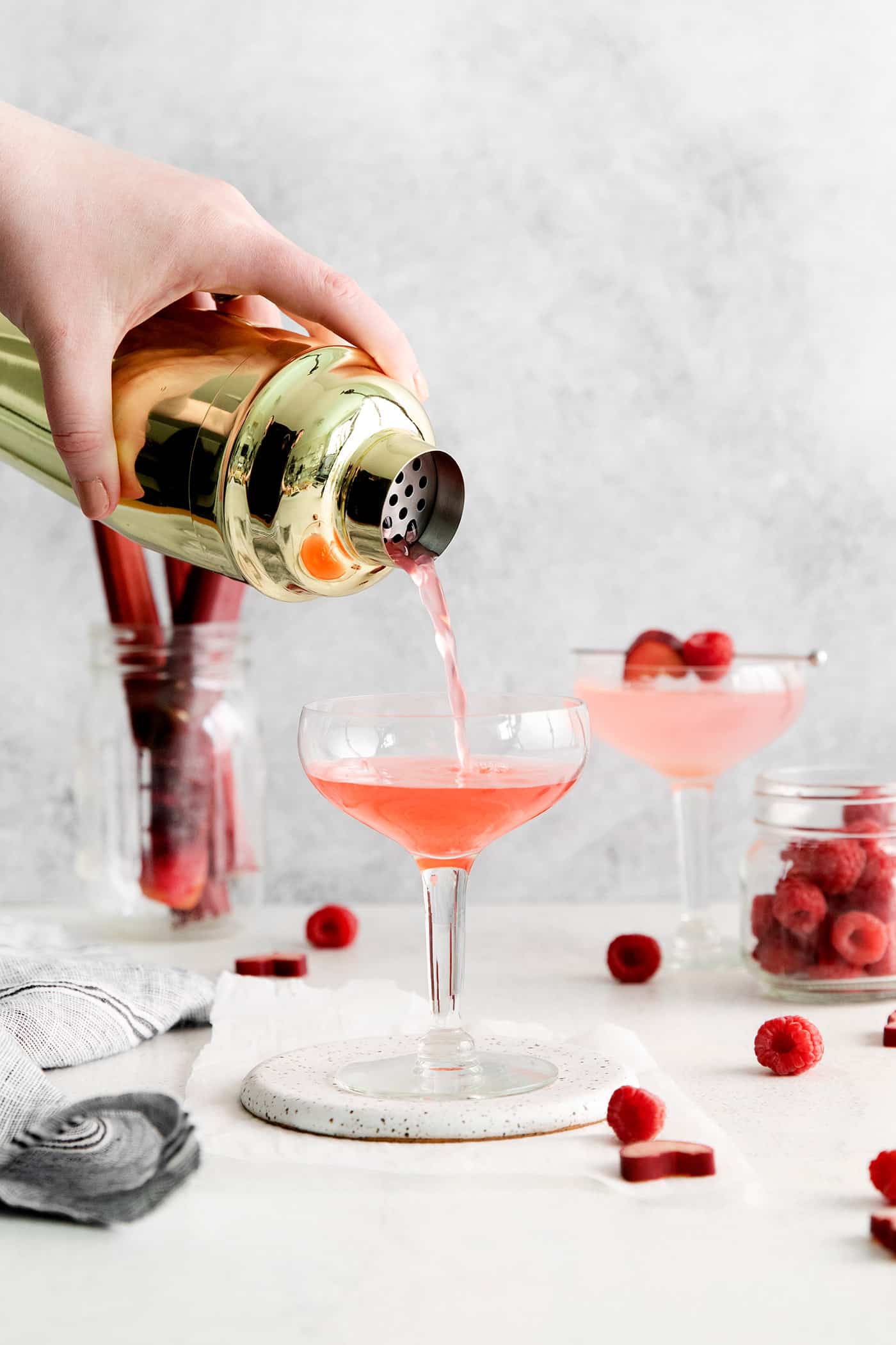 Cosmpolitan being poured from a shaker into a glass