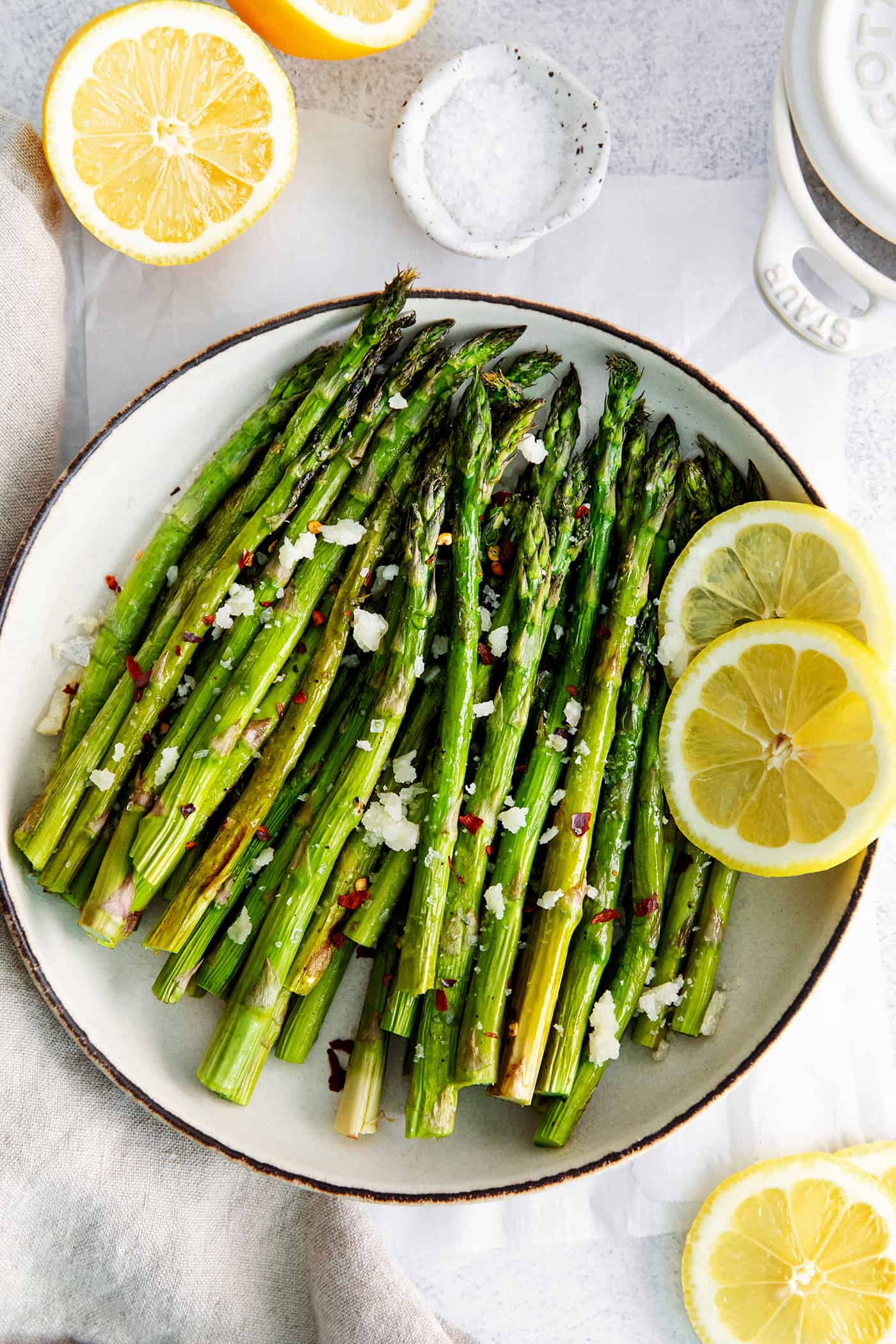 Roasted Asparagus is an easy way to make any dinner seem a bit fancier. Made with just 2 ingredients and ready in under 20 minutes! Overhead view of oven roasted asparagus