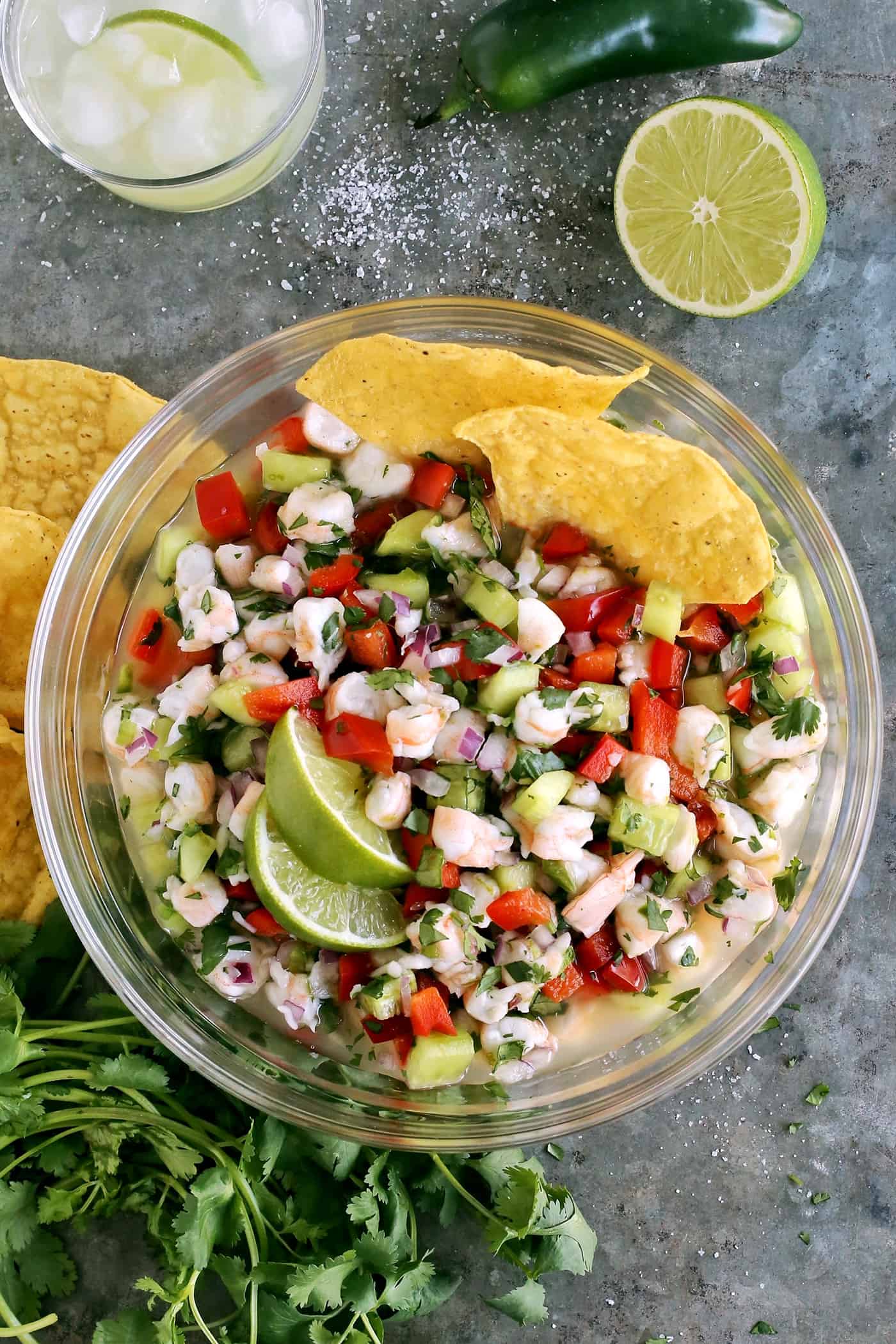 Light and refreshing, this shrimp ceviche features shrimp marinated in lime juice along with peppers, onion, and lots of fresh cilantro. Overhead view of a bowl of shrimp ceviche
