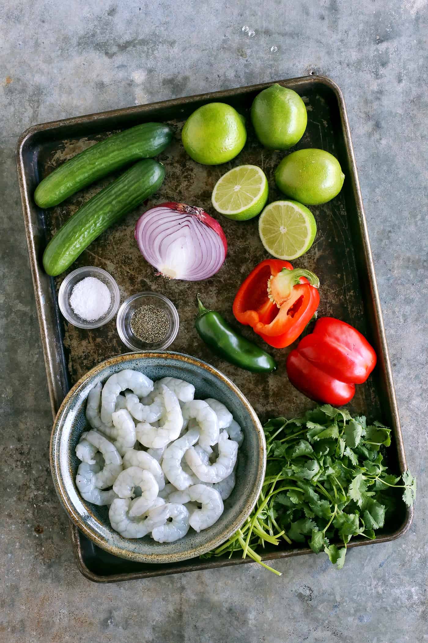 Shrimp ceviche ingredients on a baking sheet