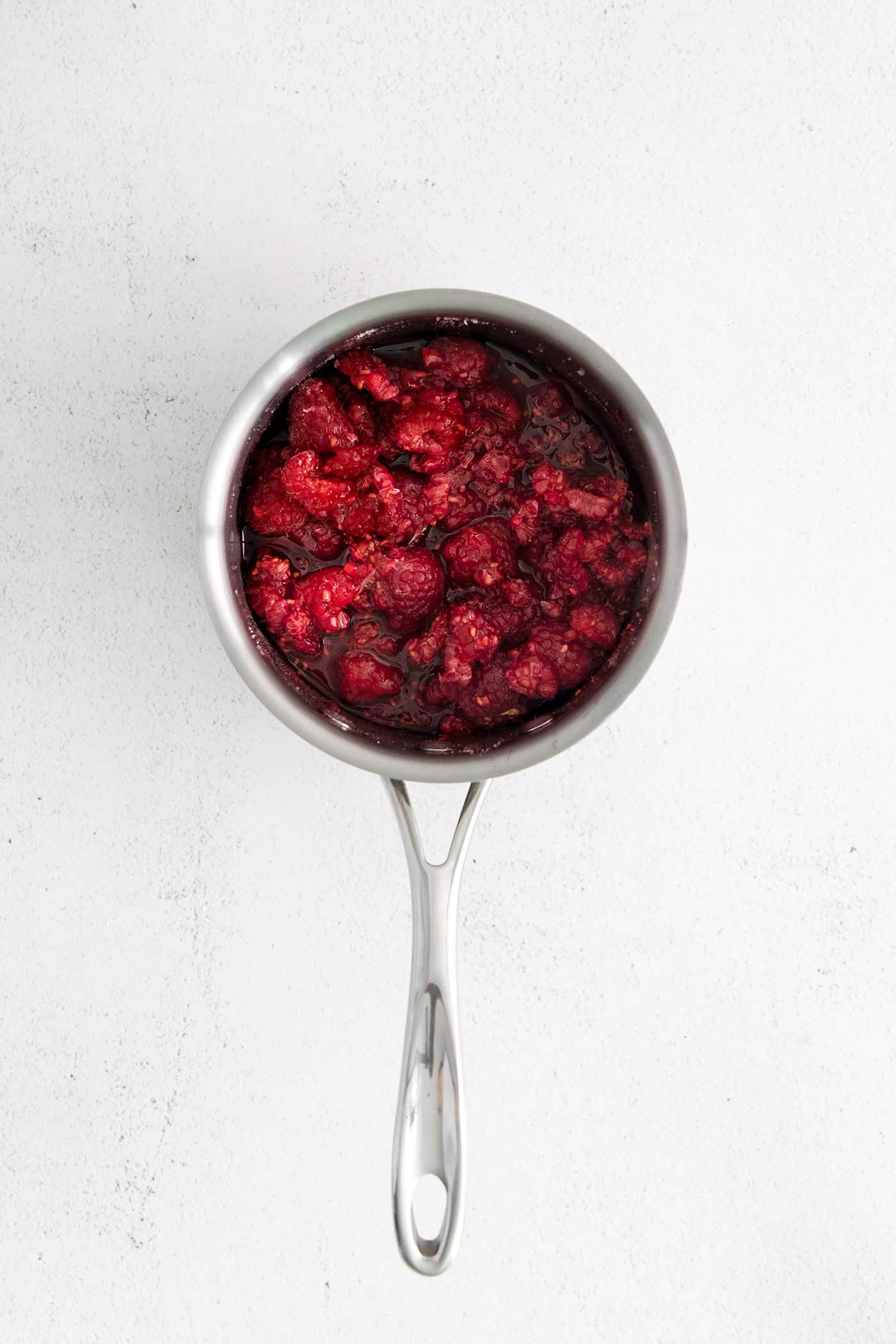 Macerated raspberries in a saucepan