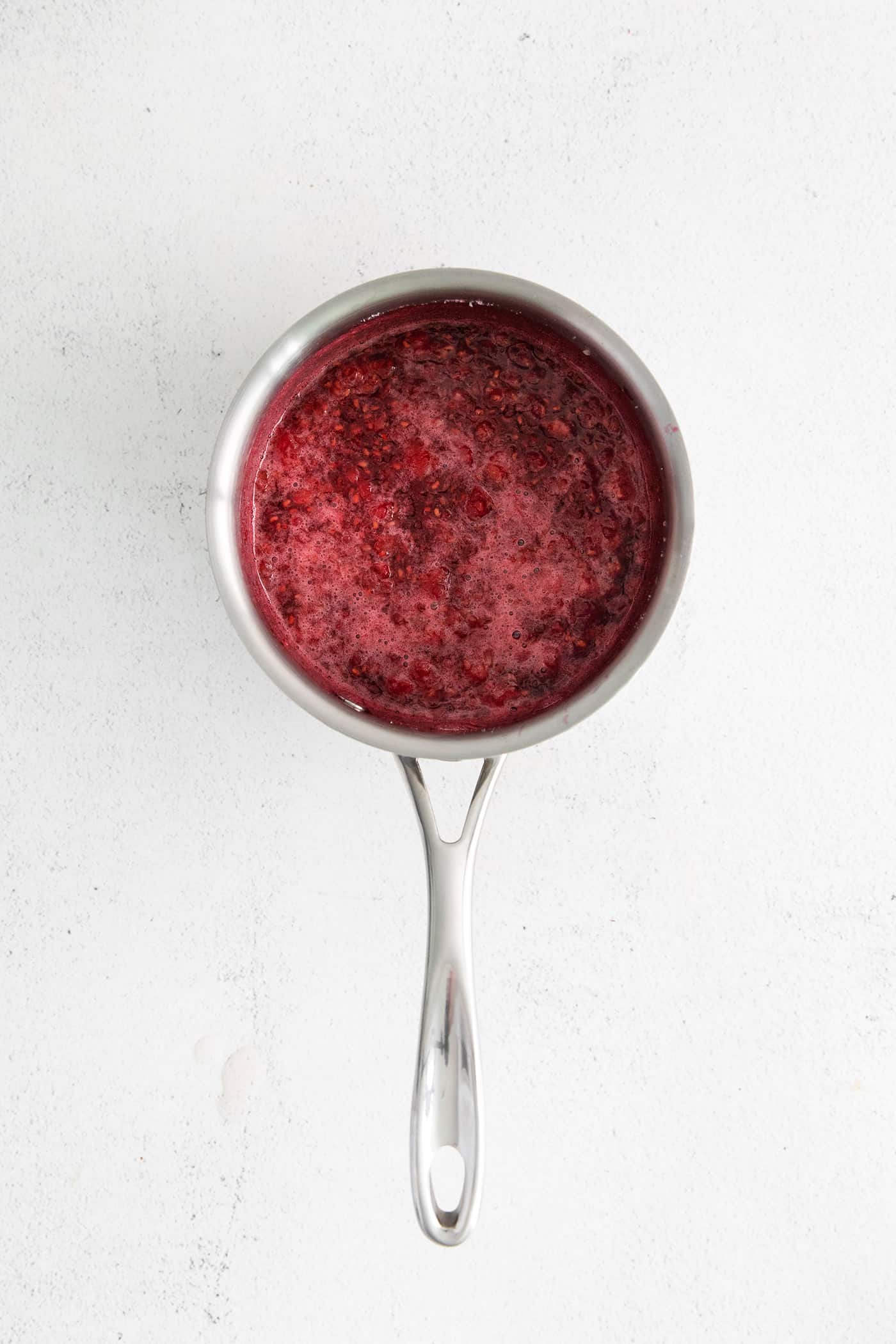 Raspberry sauce in a saucepan