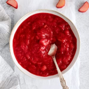 A bowl of rhubarb sauce with a spoon in it