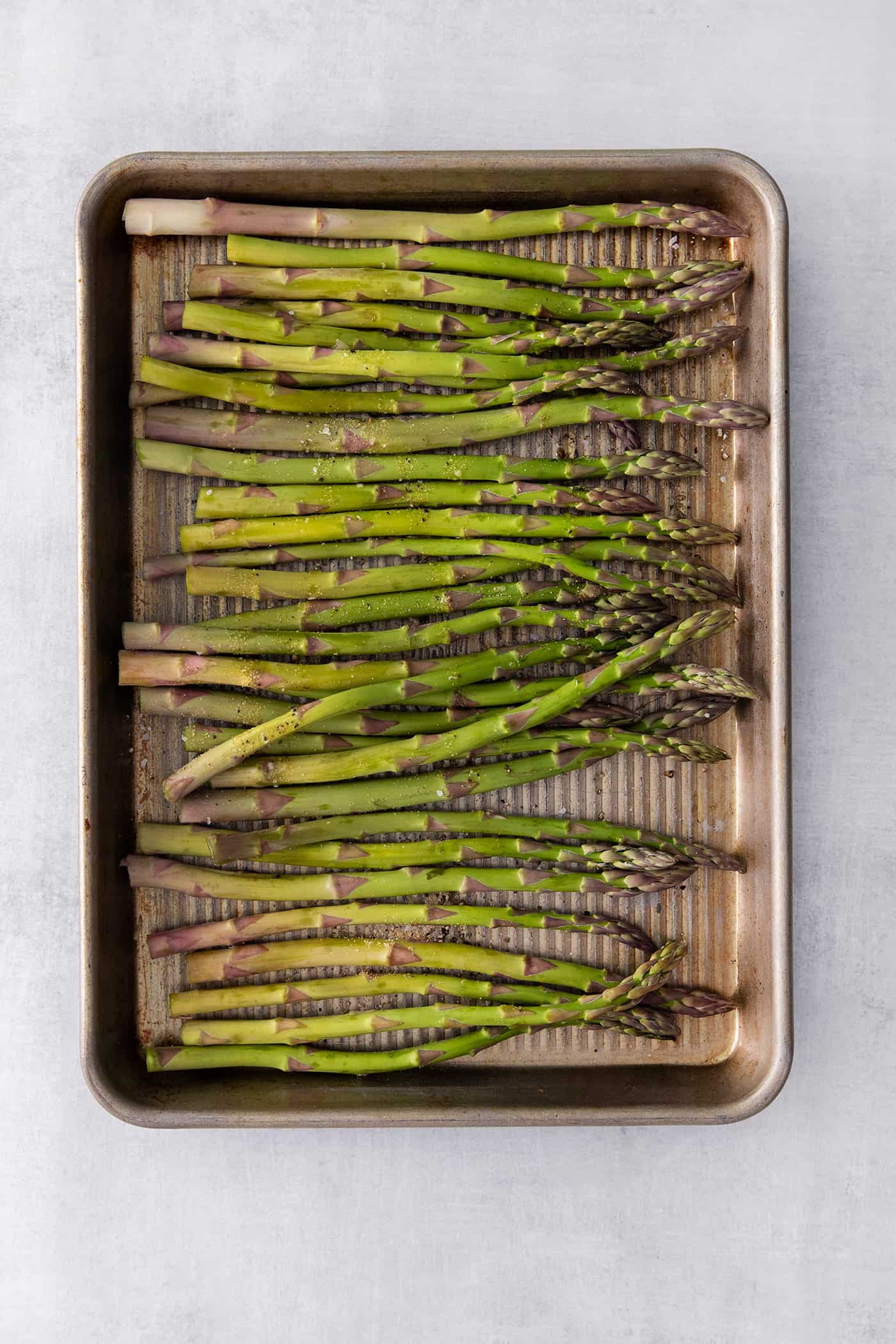 Asparagus stalks on a baking sheet