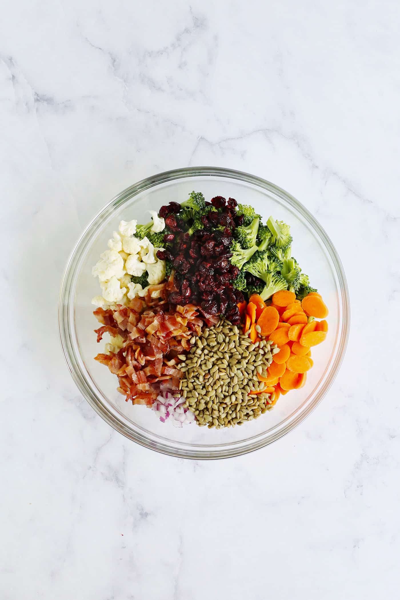 Broccoli, bacon, and other veggies in a glass bowl