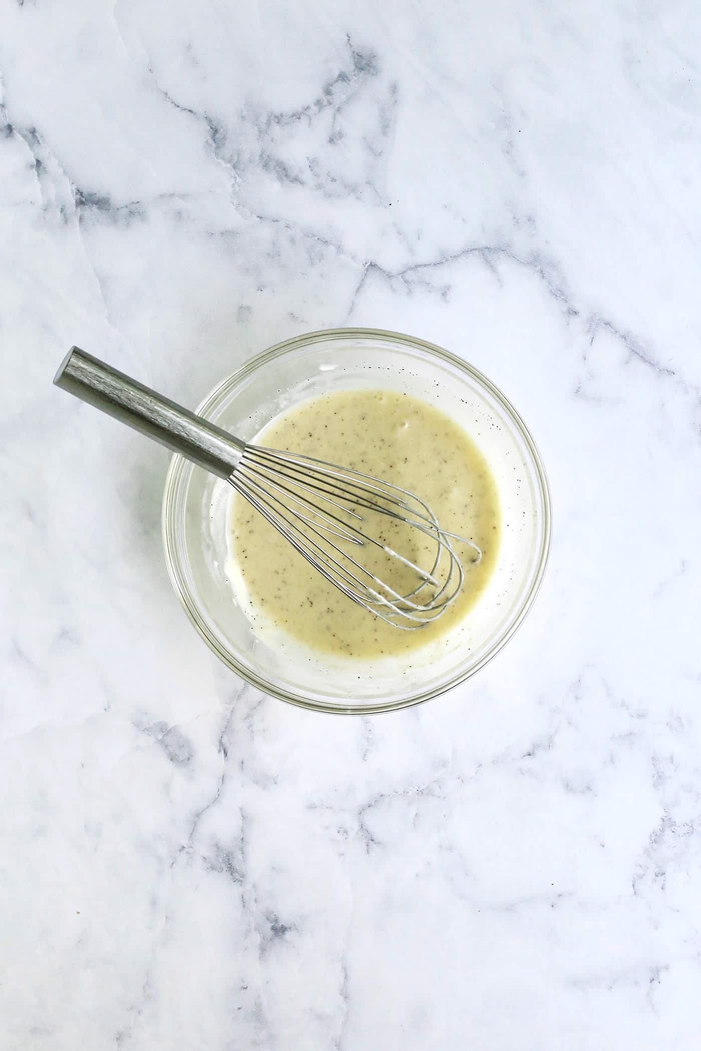 Broccoli salad dressing whisked in a small bowl