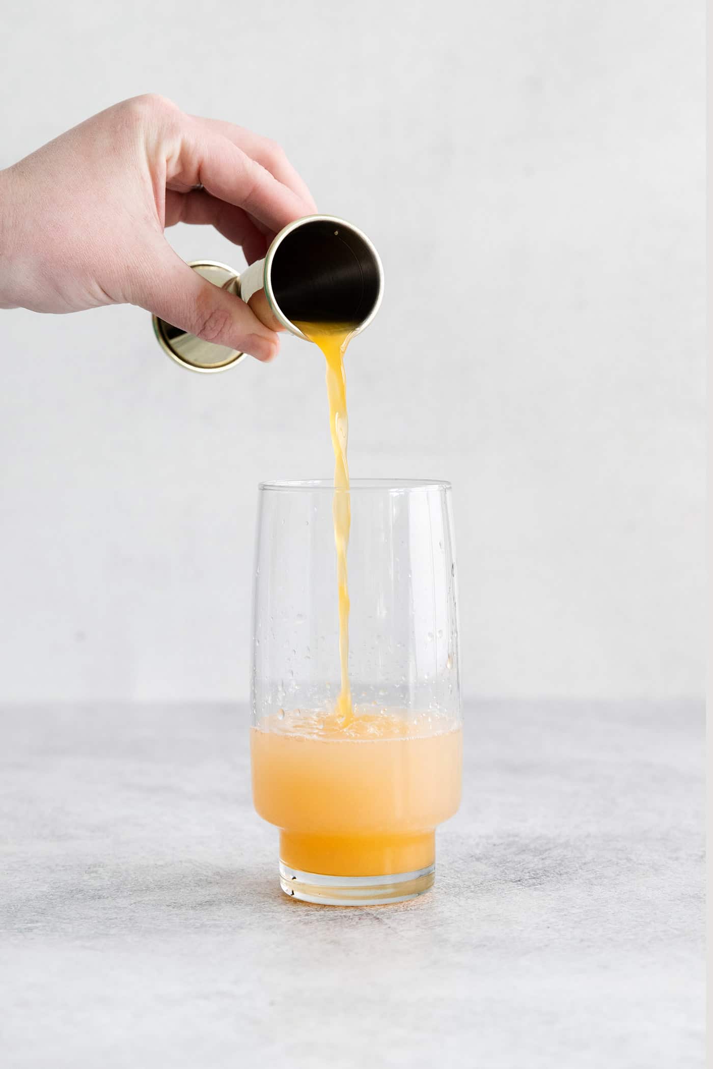 Grapefruit juice being poured into a glass