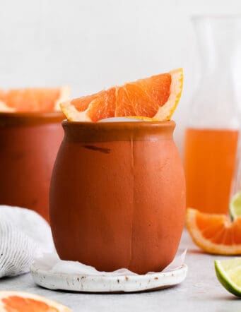 A cantarito cocktail in a clay mug