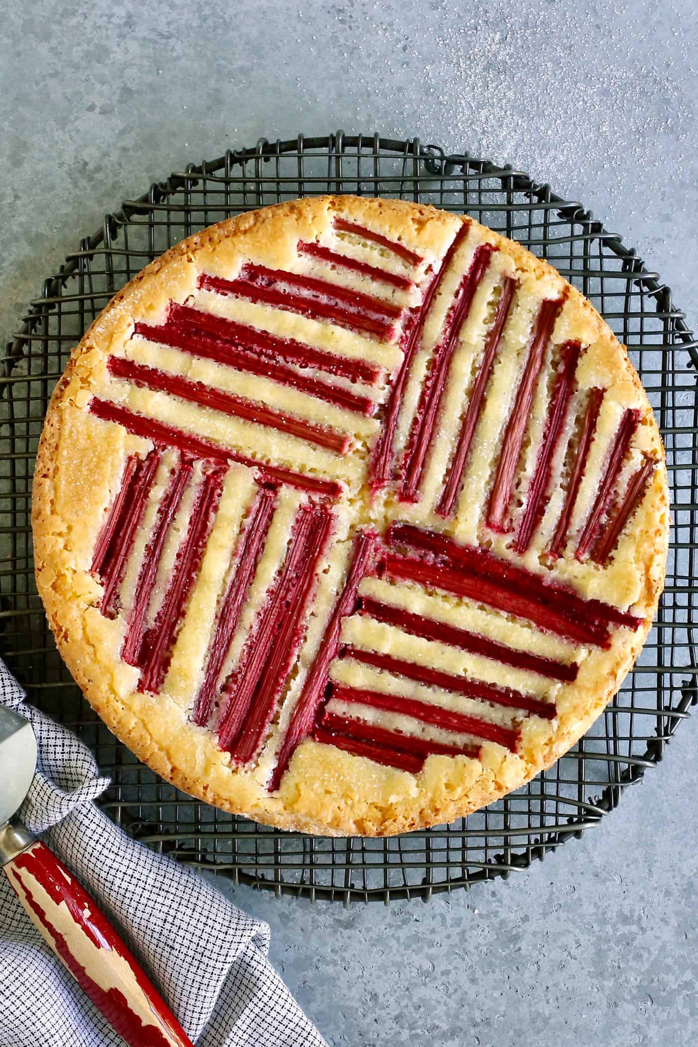 rhubarb custard cake on a cooling rack