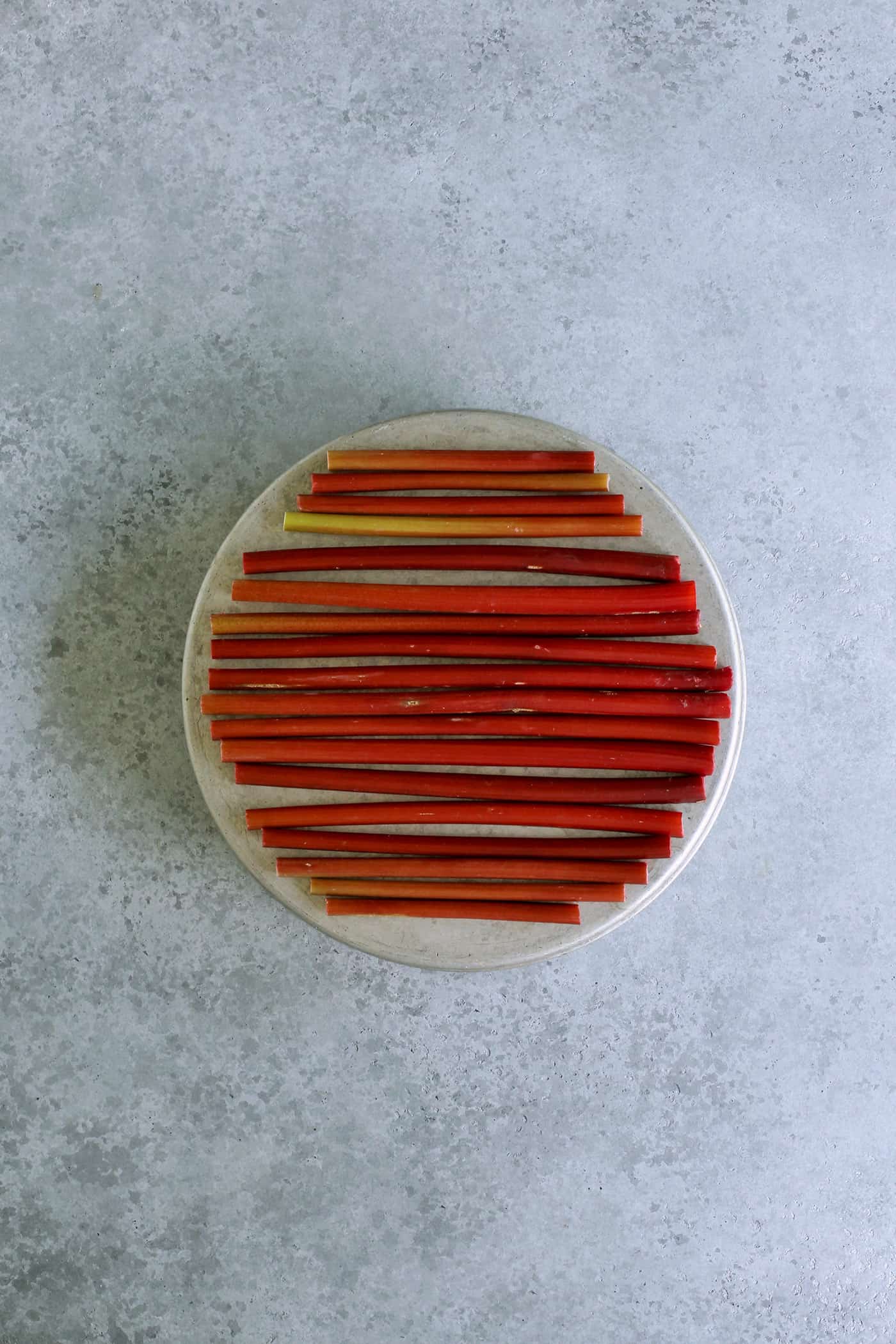 rhubarb lined up on a round cake pan