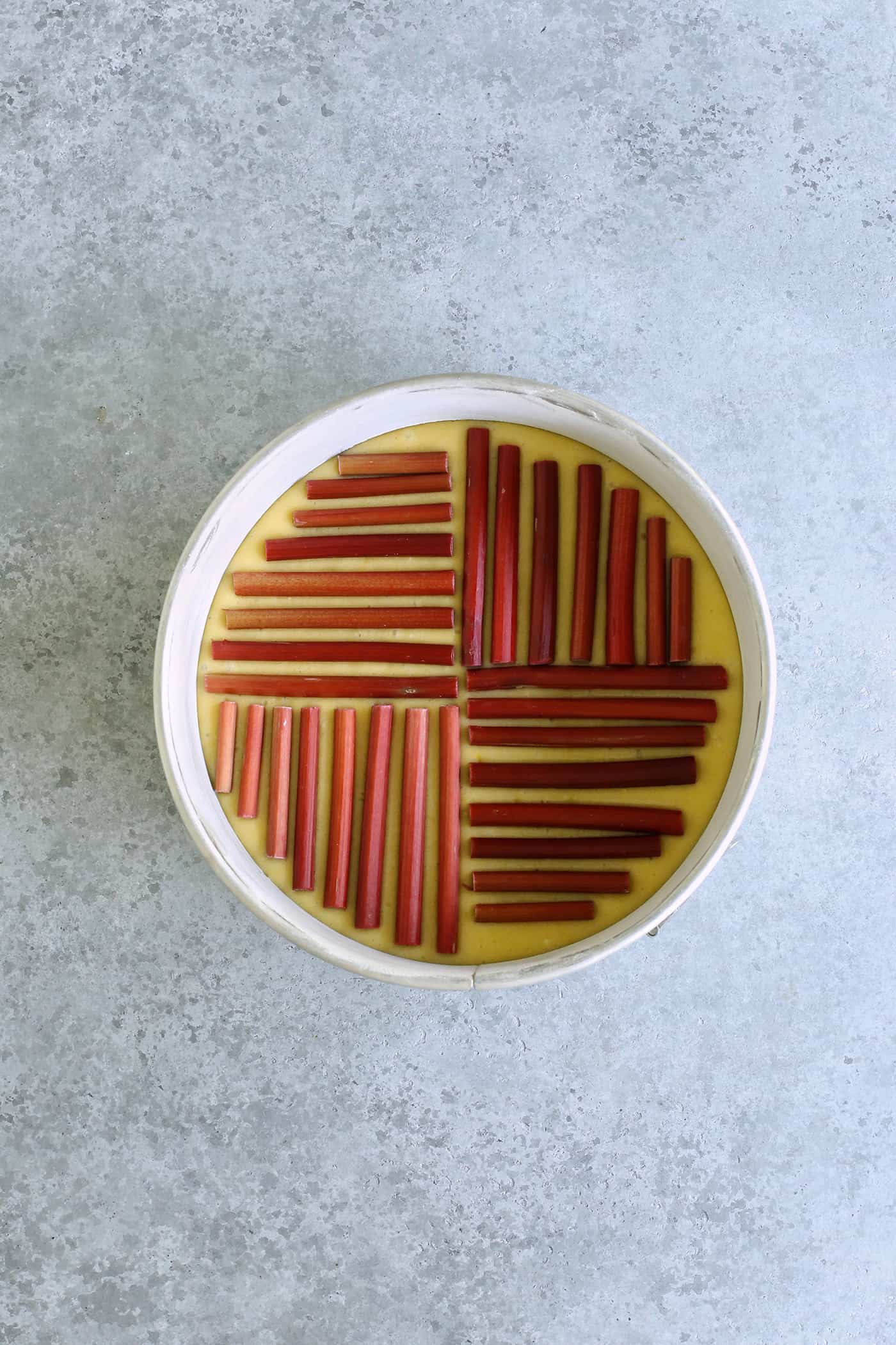 rhubarb lined up on the top of the cake batter