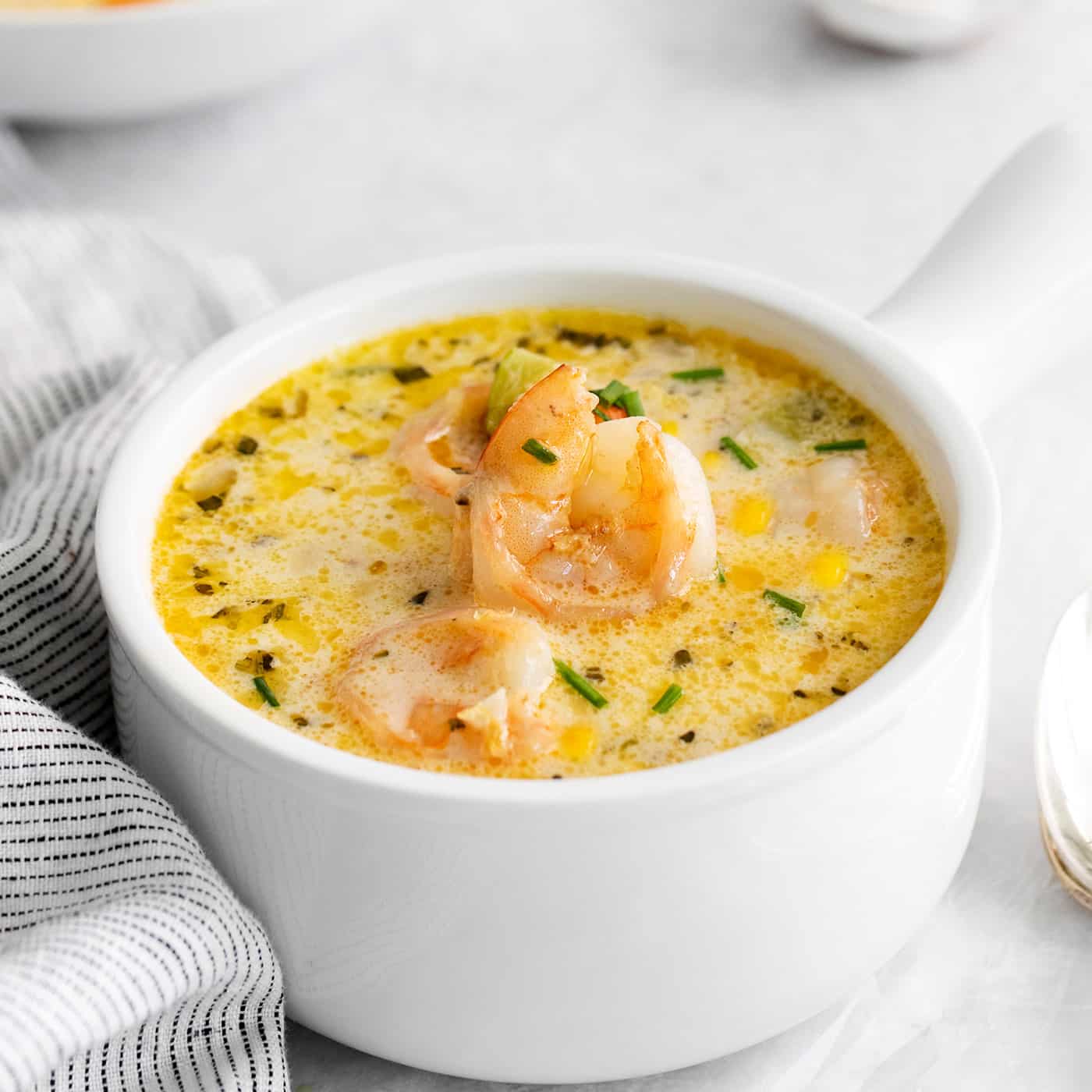 Angled view of a bowl of shrimp and corn chowder