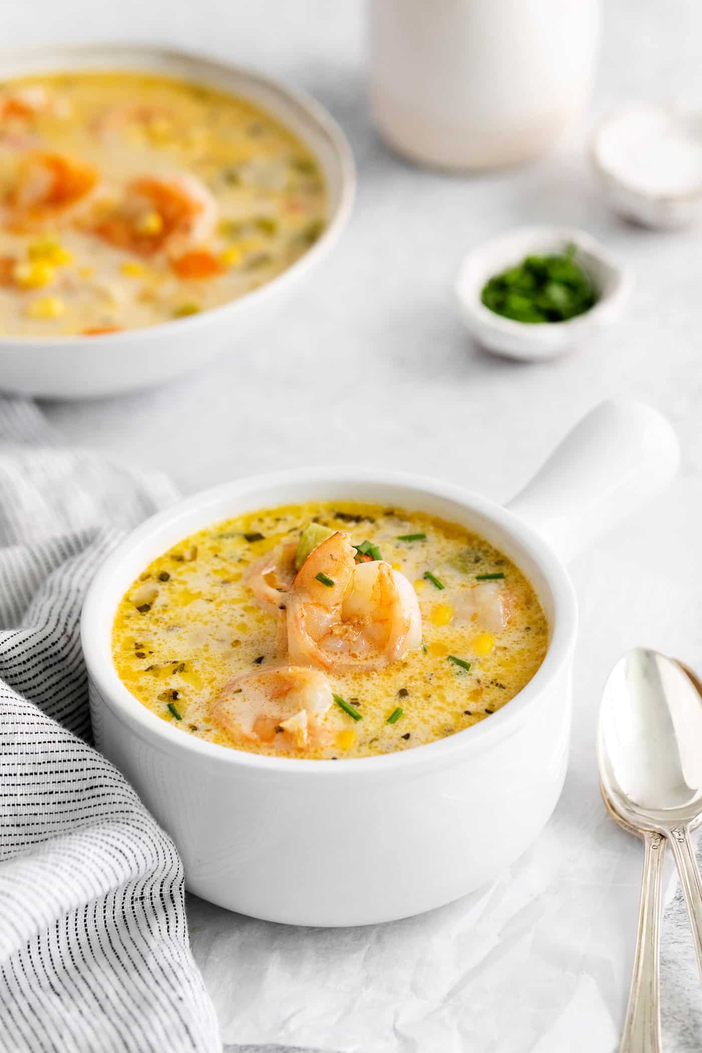 Angled view of a bowl of shrimp and corn chowder