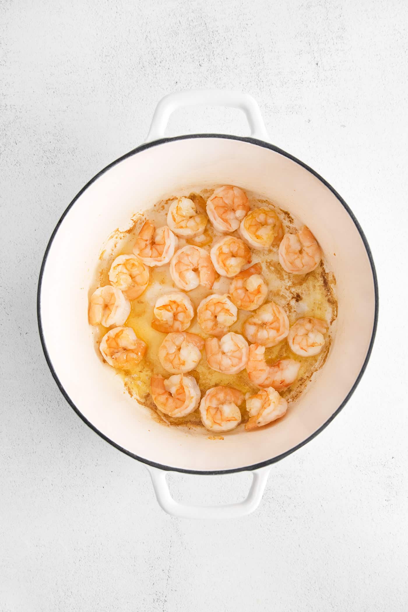 Shrimp sauteing in a pan