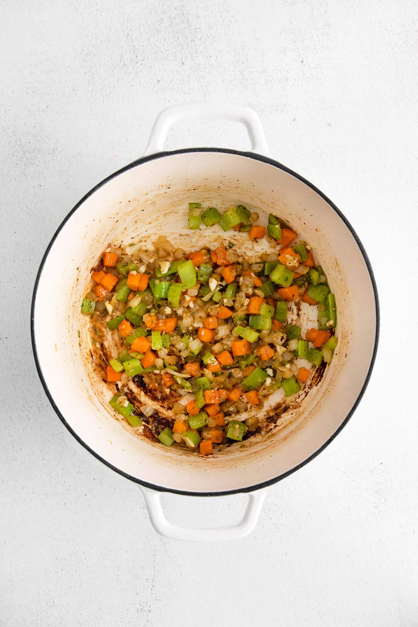 Carrots, celery, and onions in a pan with flour