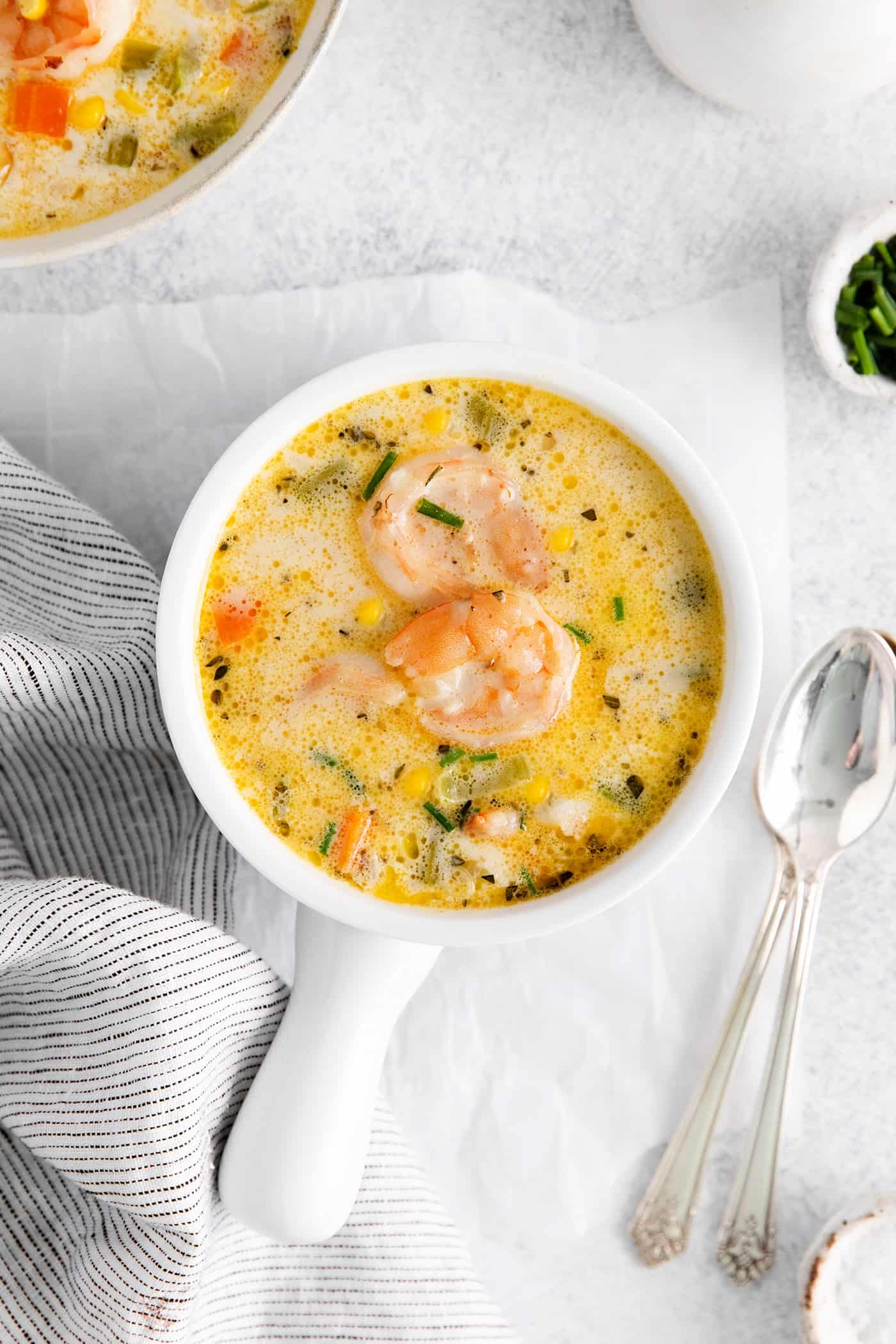 Overhead view of a bowl of shrimp and corn chowder