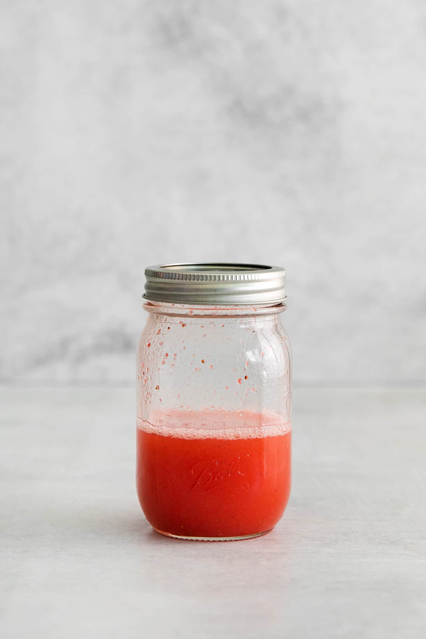 a cocktail shaker jar, with a shaken margarita