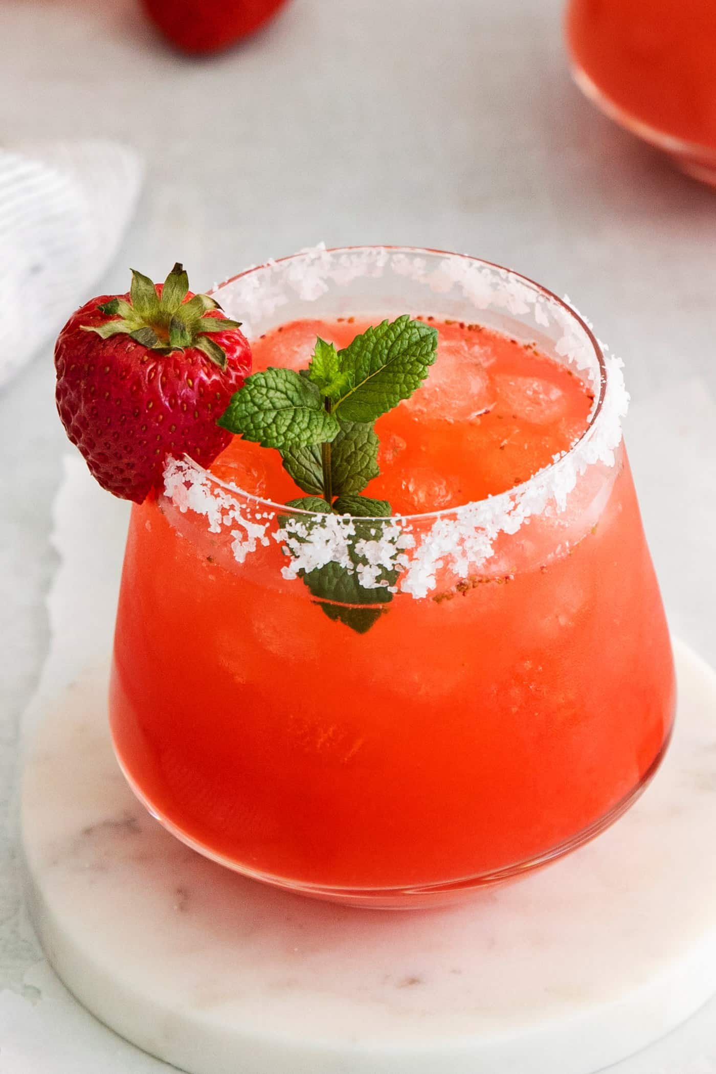 close-up of strawberry margarita with a sprig of fresh mint