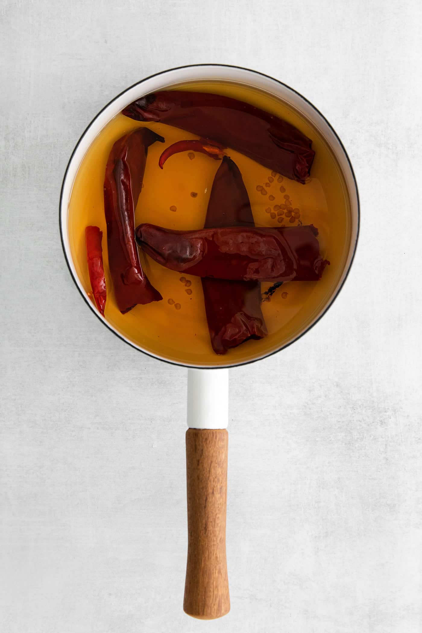 Dried peppers soaking in a pot of water