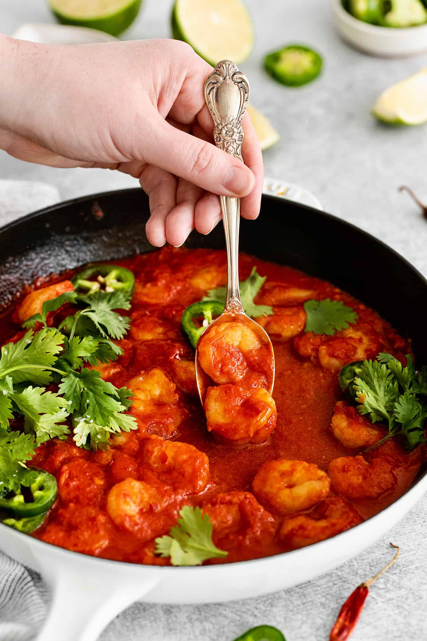 A fork grabbing a diablo shrimp from the skillet