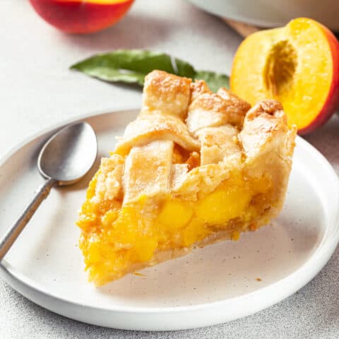 a piece of peach pie on a plate