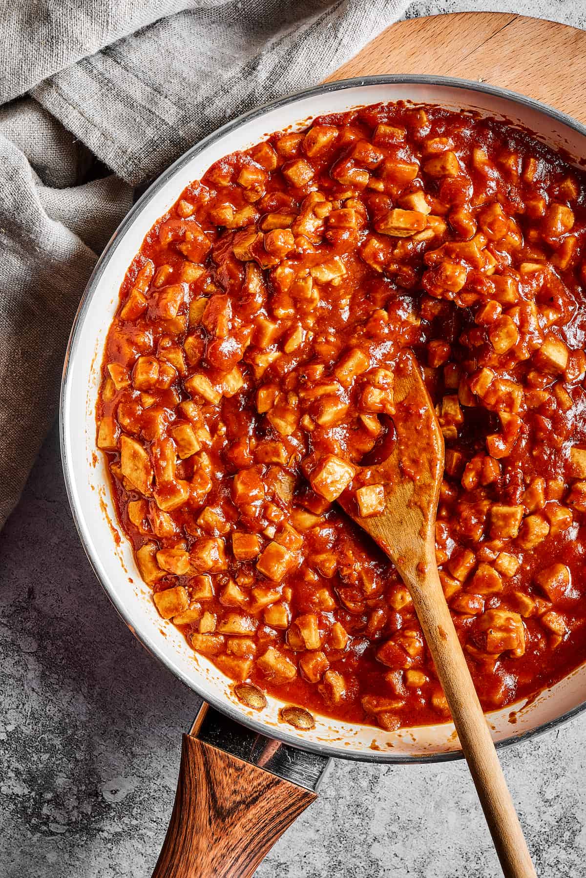 A wooden spoon stirring sofritas