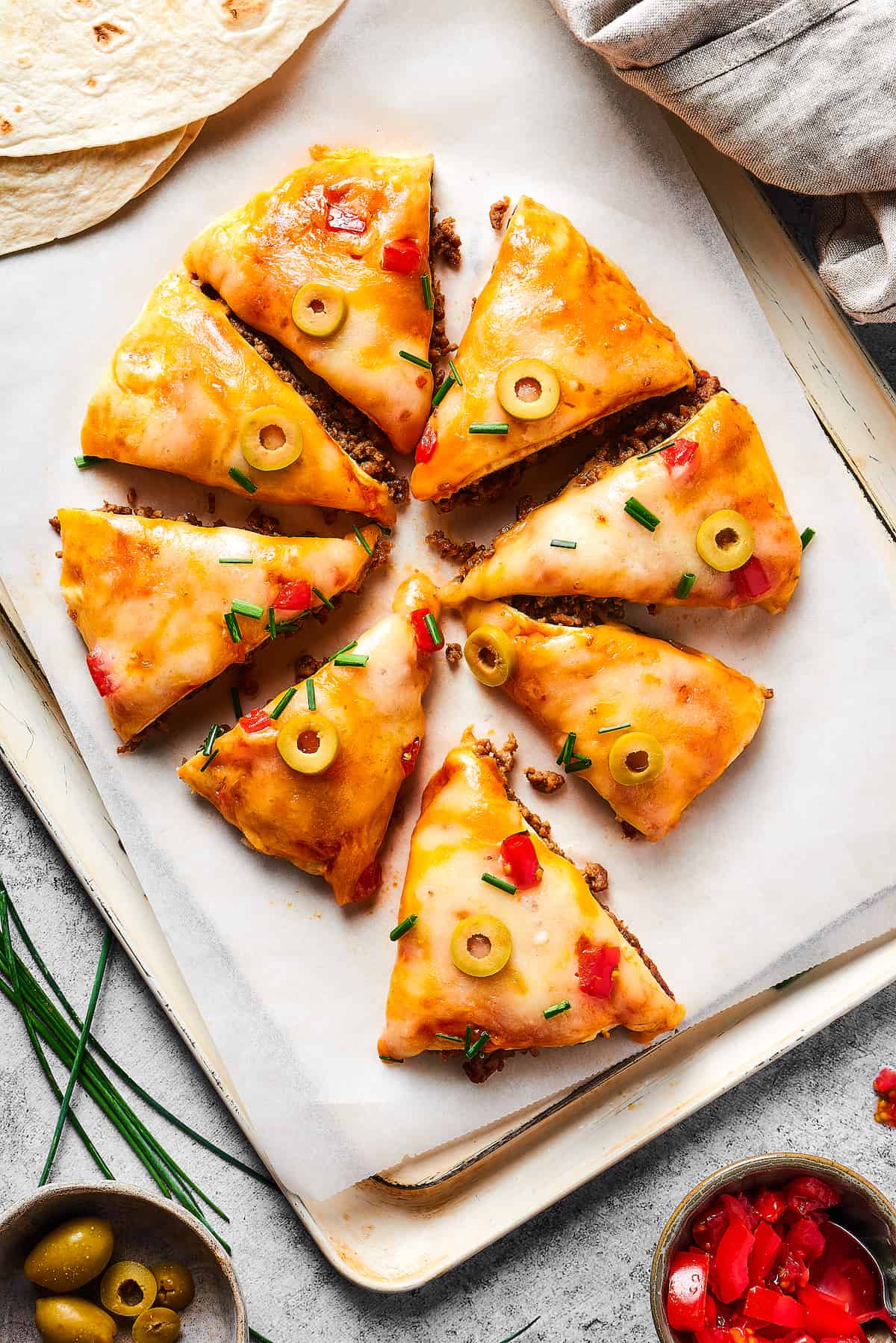 Overhead view of a Mexican Pizza cut into triangles