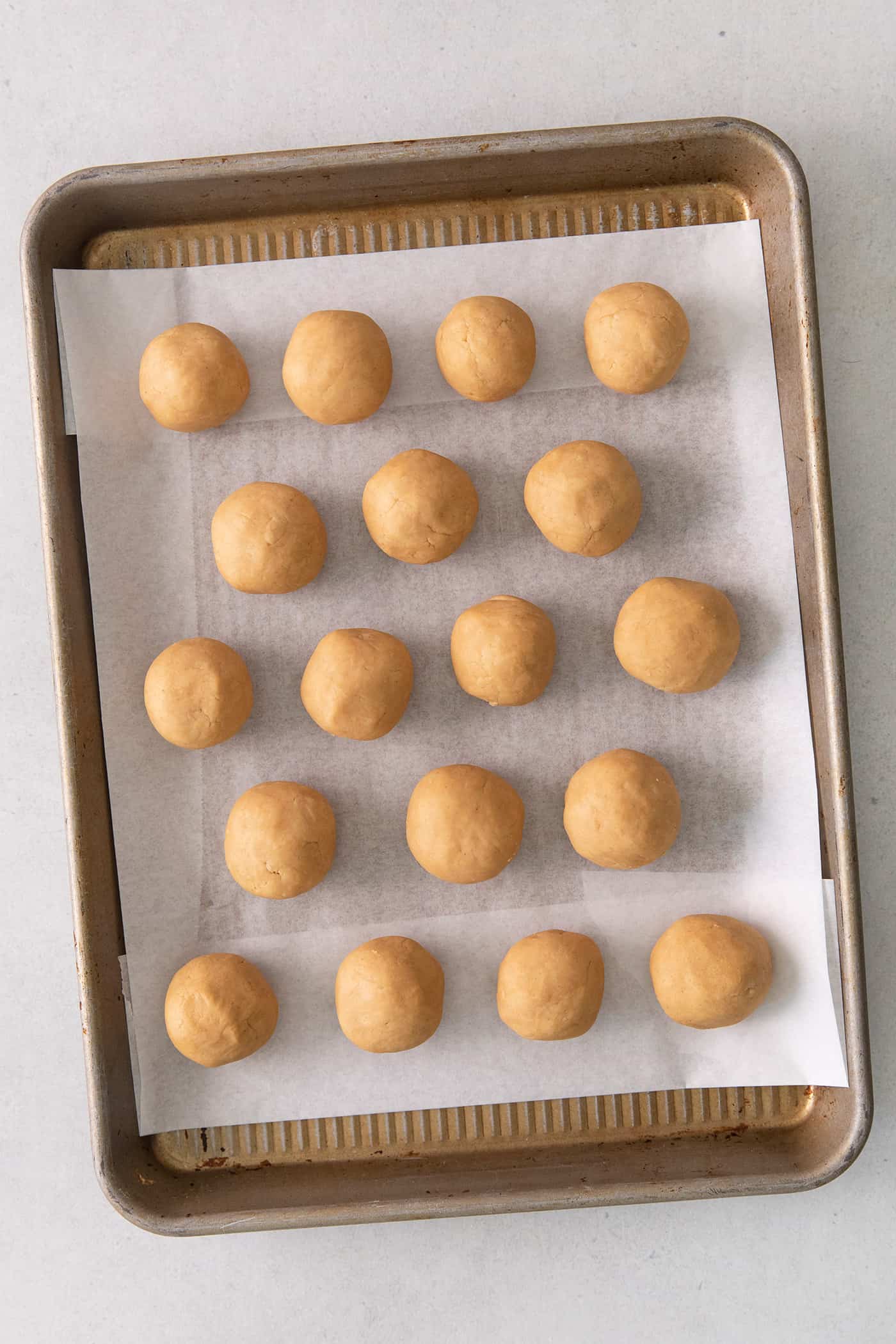 Peanut butter balls on a cookie sheet