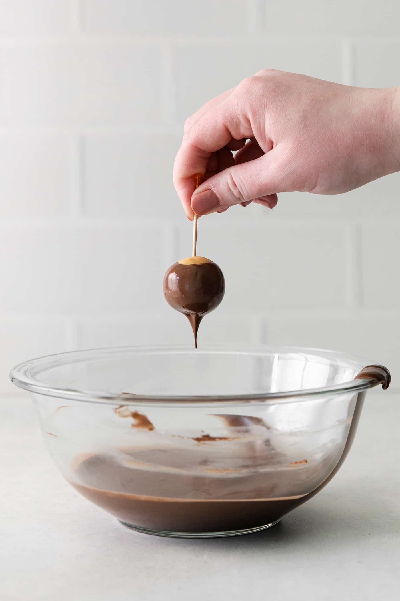 A hand reaching for a buckeye 