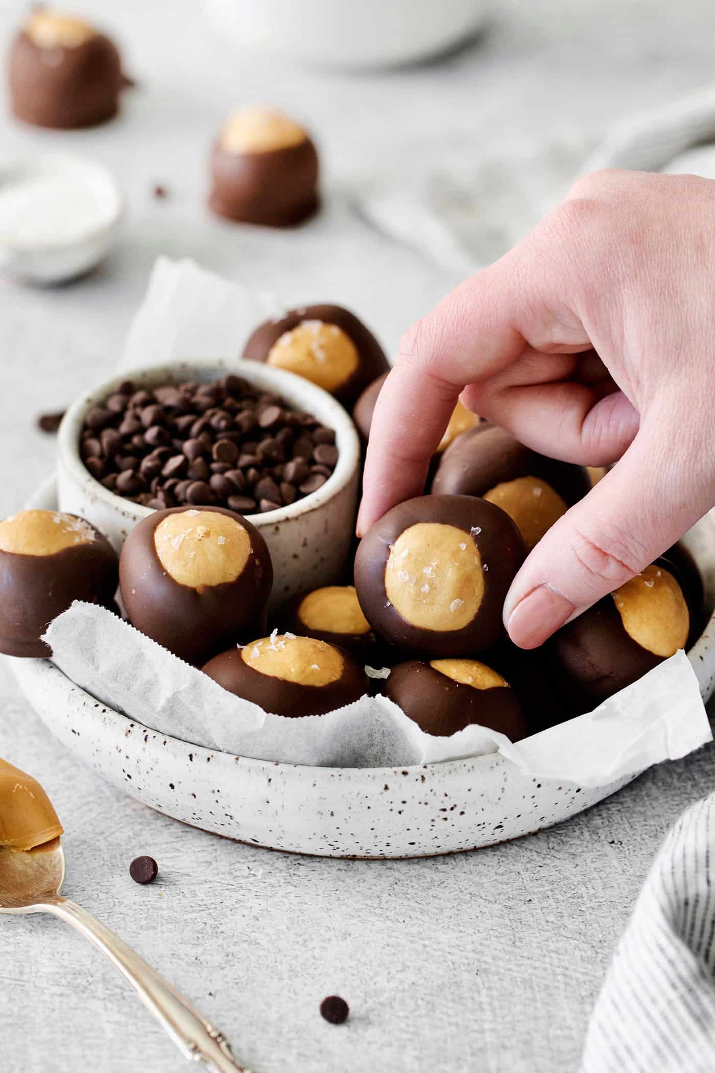 A hand grabbing a buckeye candy