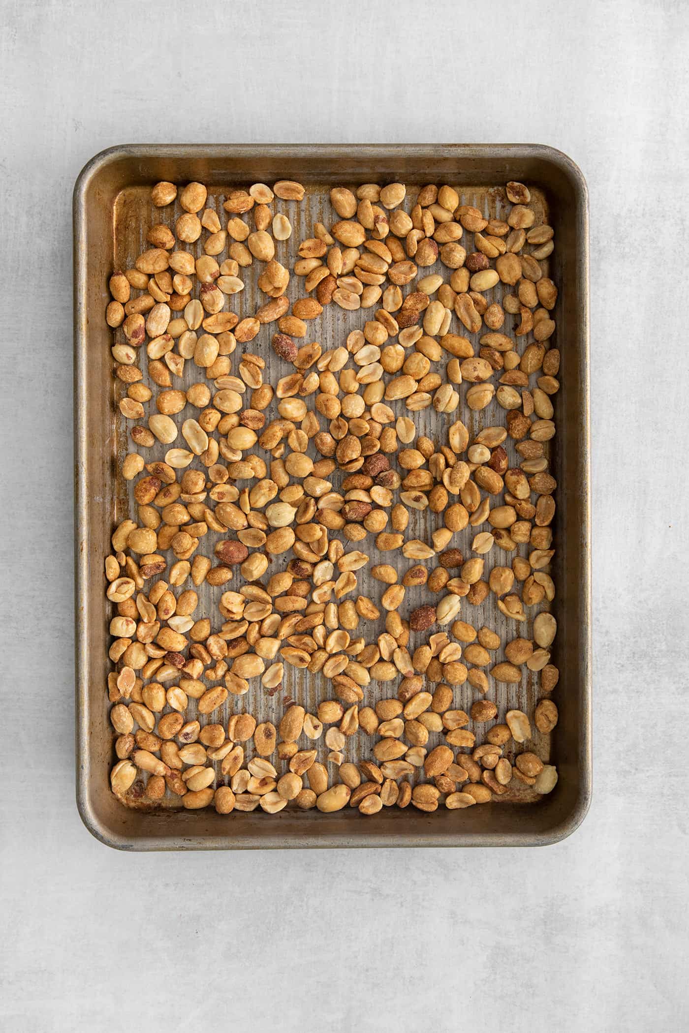 peanuts spread out on a rimmed pan