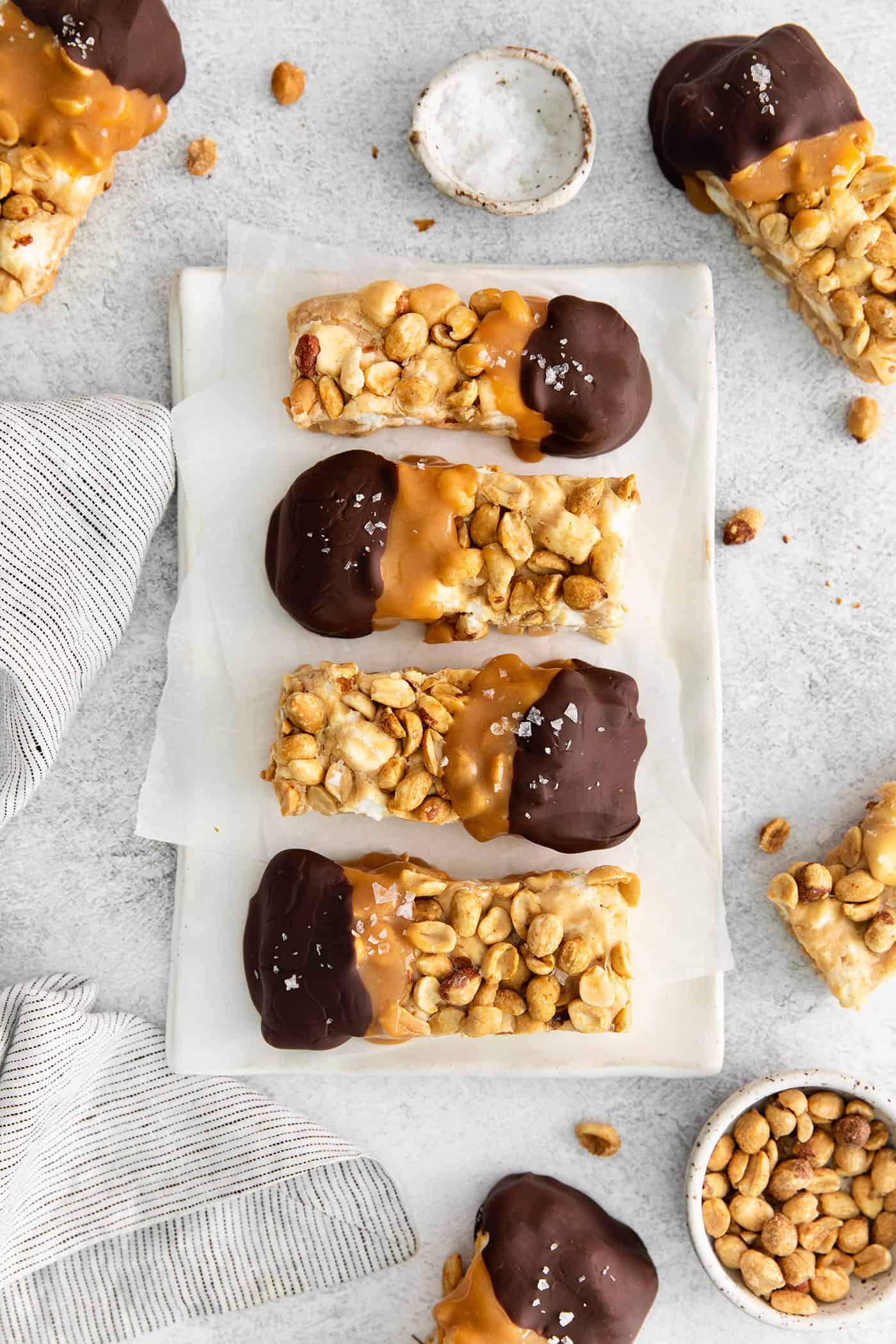 salted nut roll bars dipped in caramel and chocolate and sprinkled with flaky sea salt