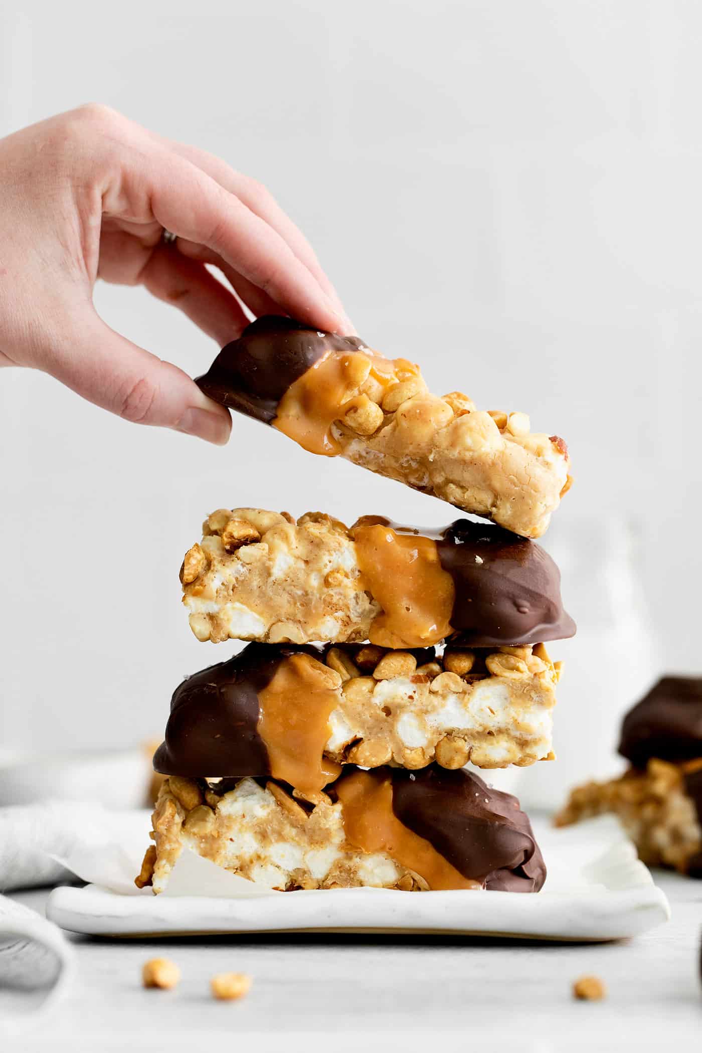 a stack of salted nut roll bars on a plate