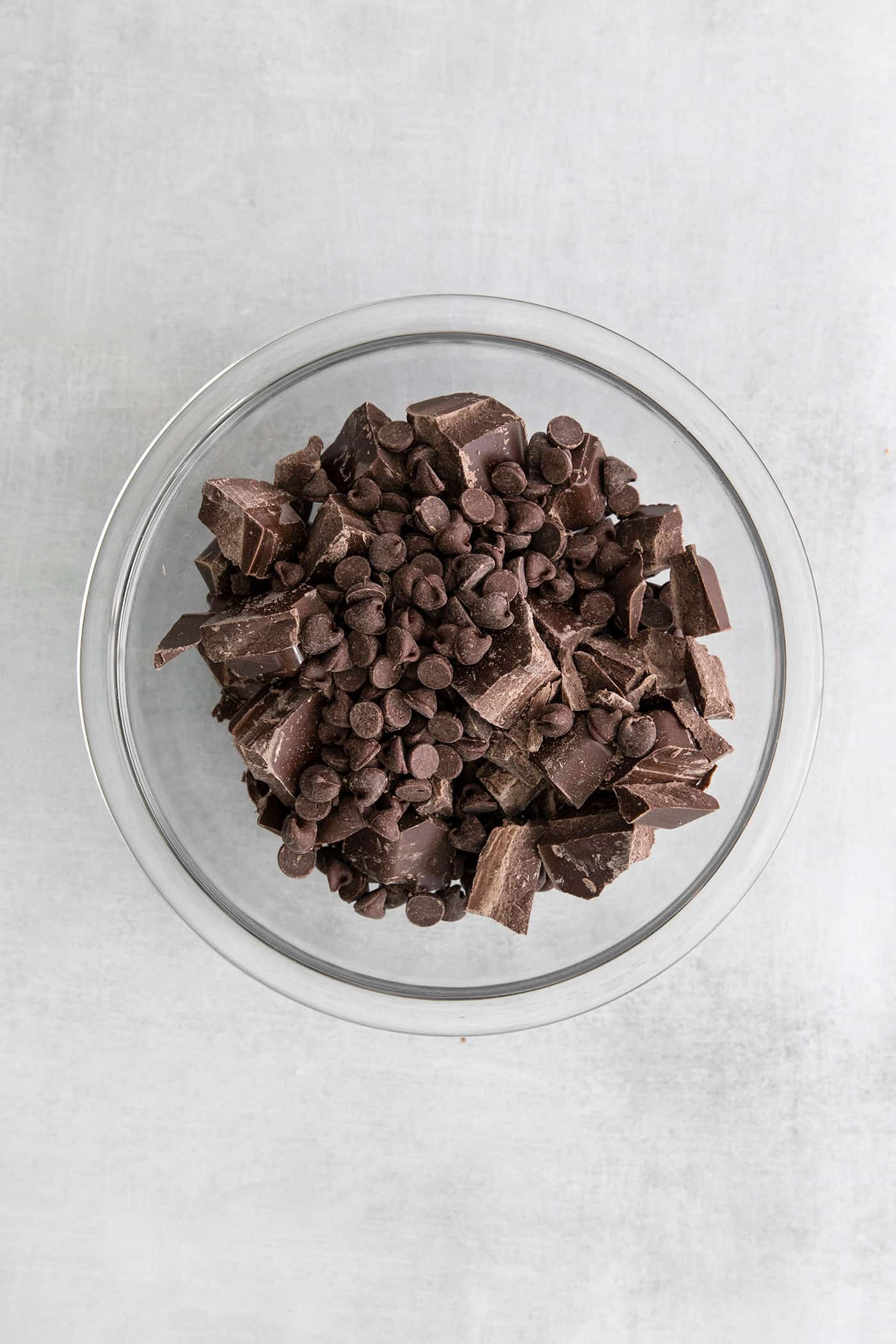chocolate chips and chopped chocolate bark in a clear bowl