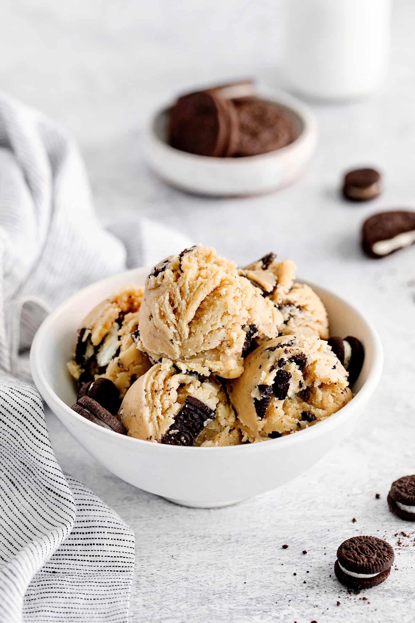 This Edible Oreo Cookie Dough is perfectly soft and sweet, with crunchy bits from chocolatey Oreo cookies. Grab a few friends and dig in! A bowl with scoops of edible oreo cookie dough