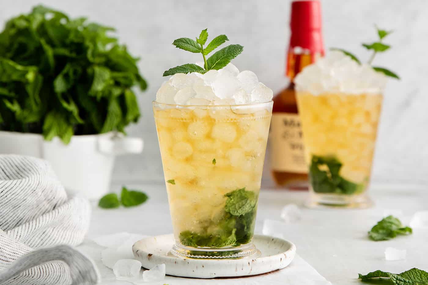 A mint julep cocktail in a clear glass