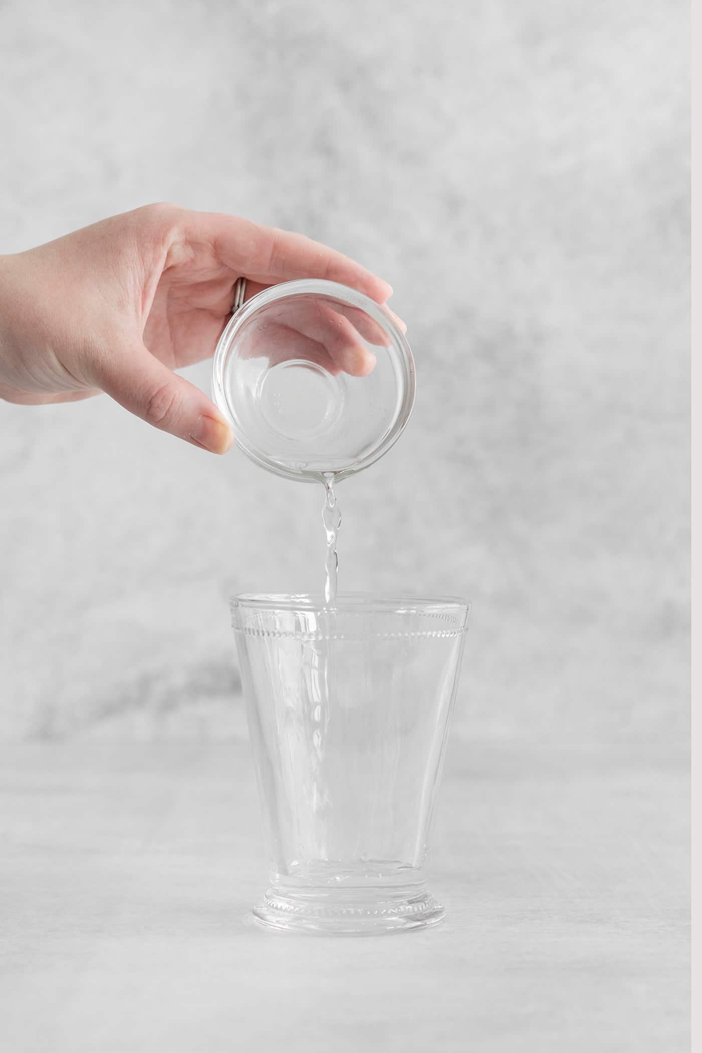 Simple syrup being poured into a glass