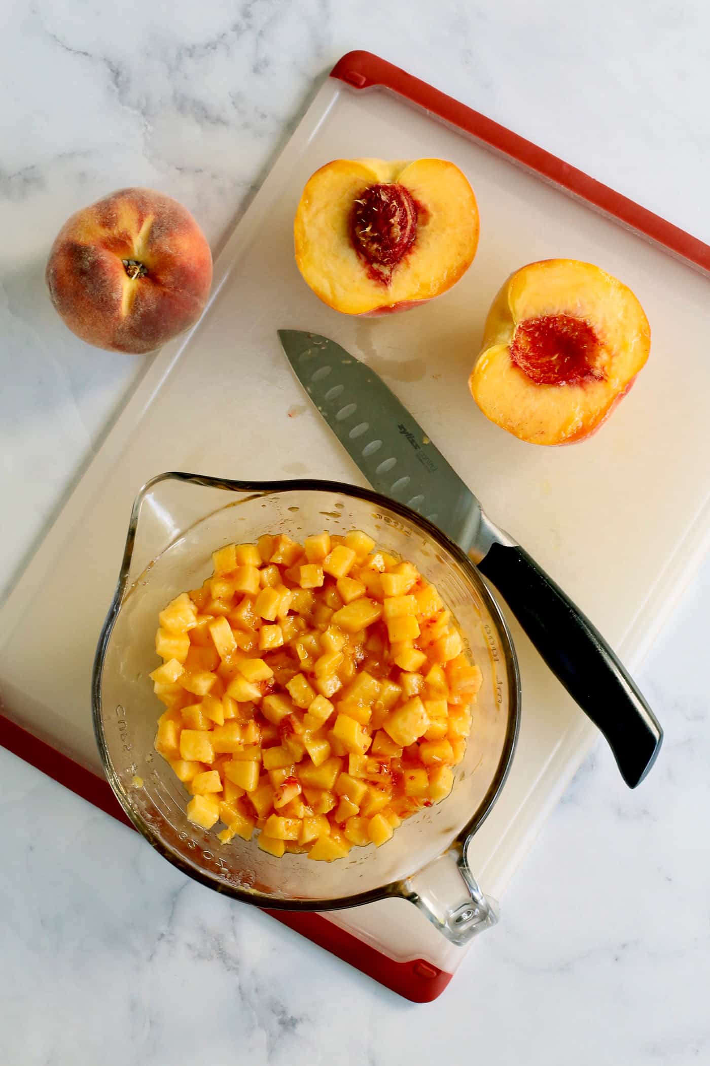 chopping fresh peaches on a cutting board