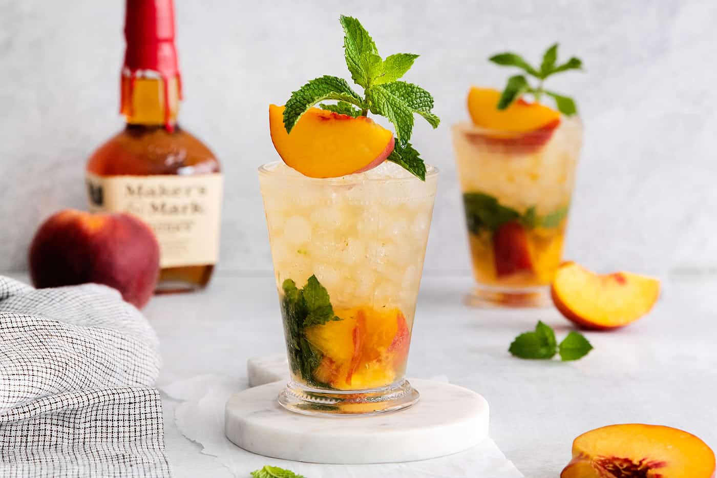 Two peach mint julep cocktails