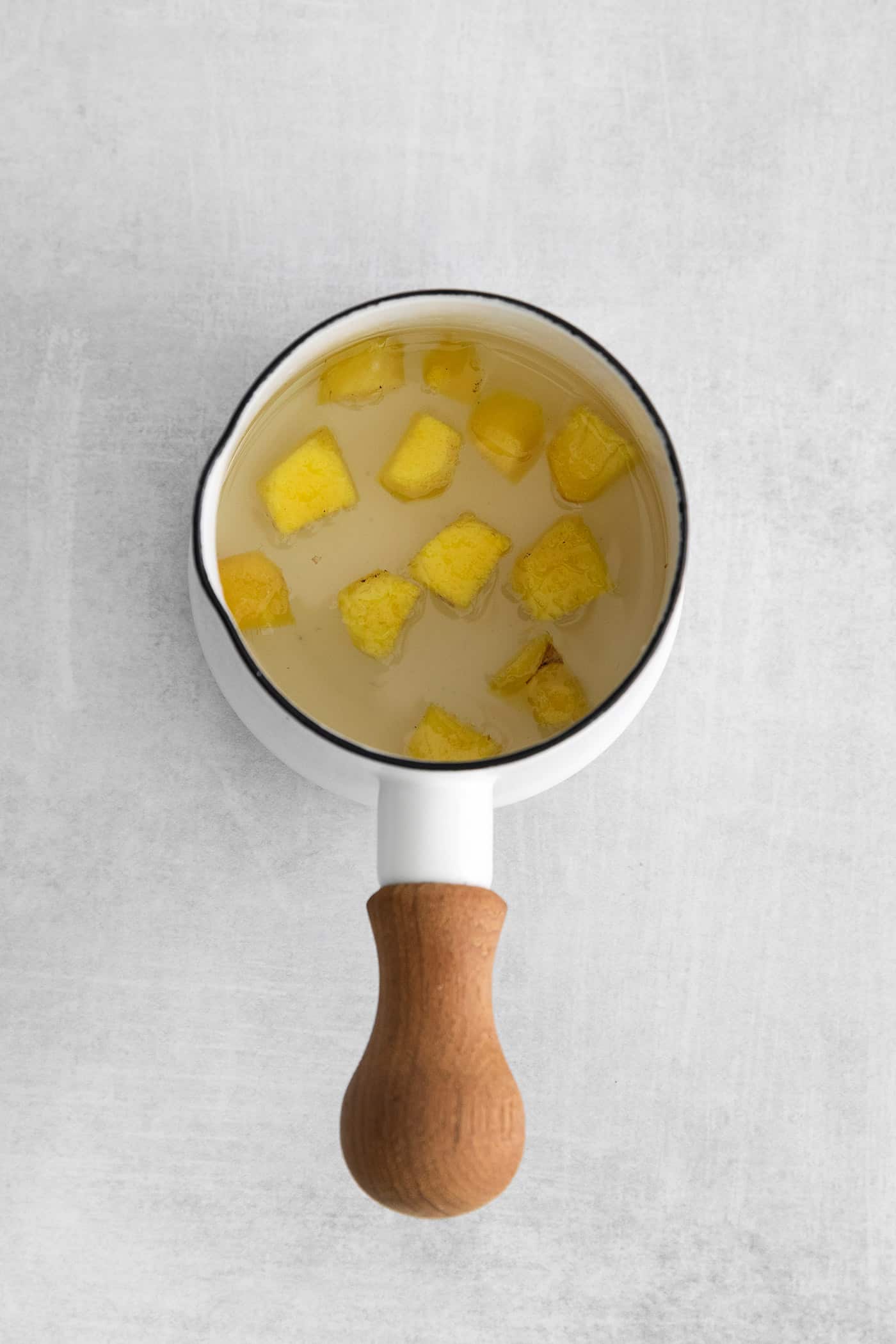 Overhead view of ginger simple syrup in a saucepan