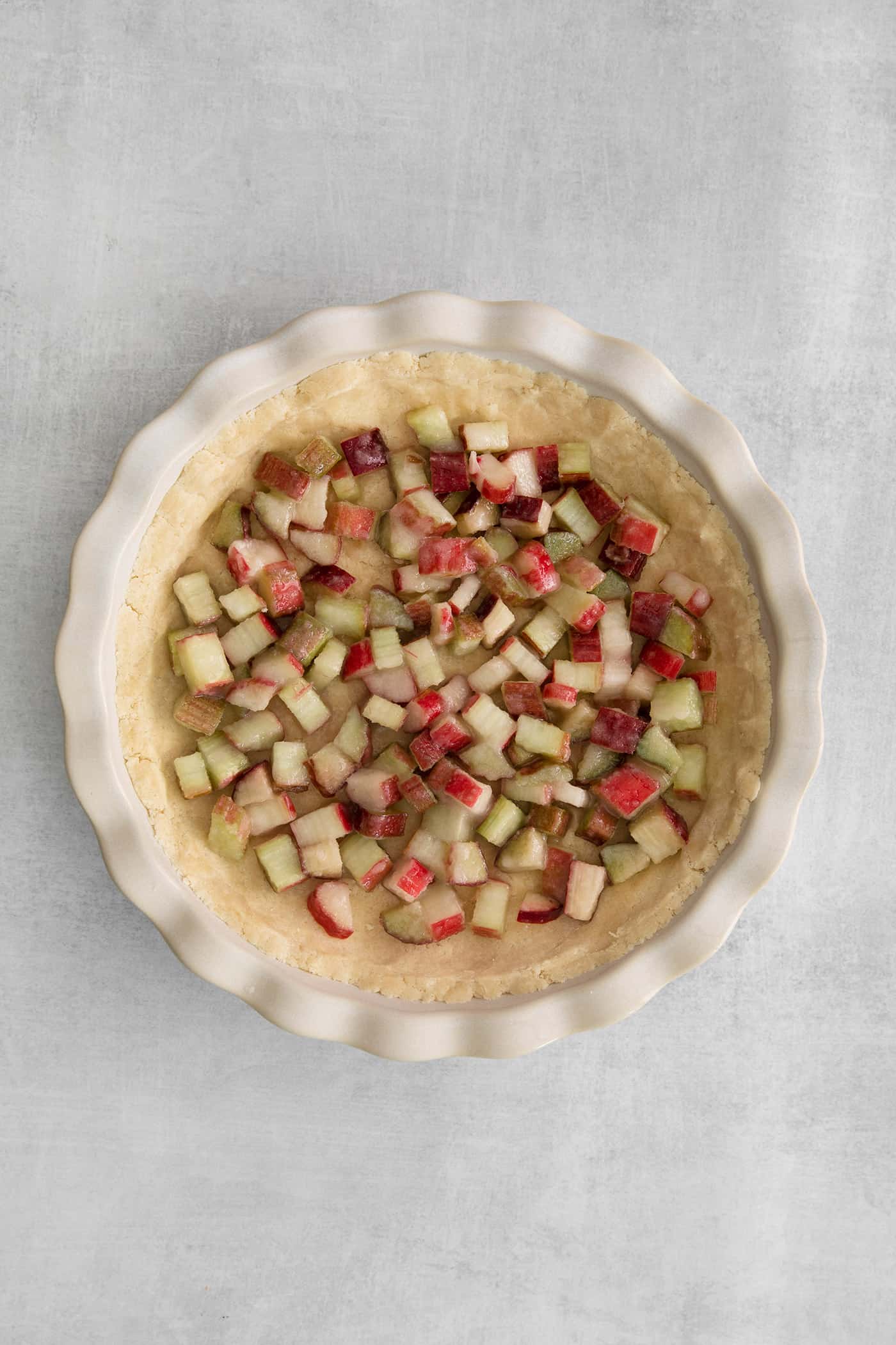 rhubarb spread across the pie crust in a pie plate