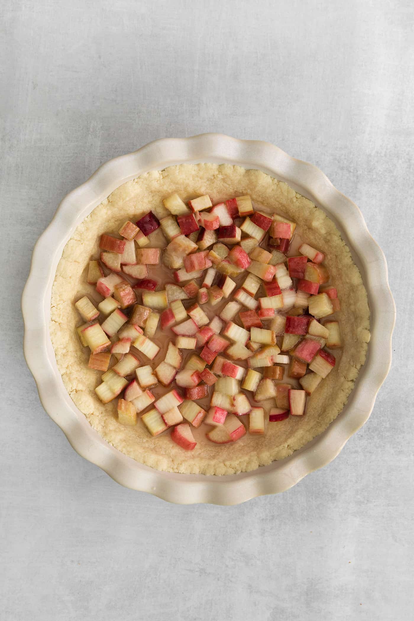 rhubarb spread across the pie crust in a pie plate