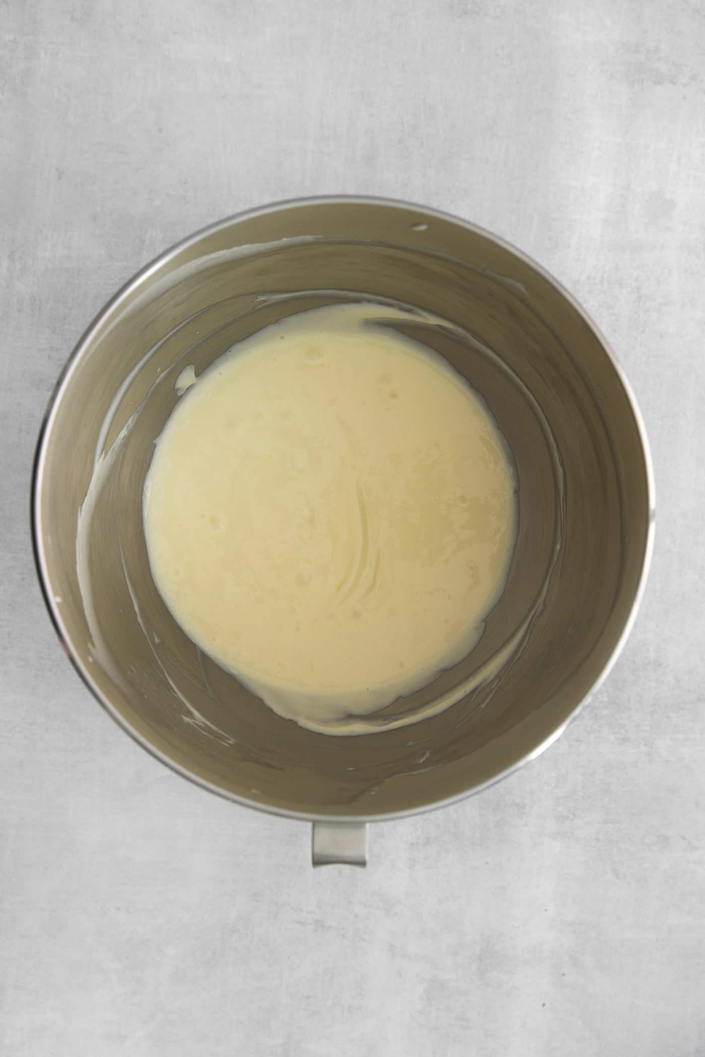 cheesecake layer mixed in a stainless steel bowl