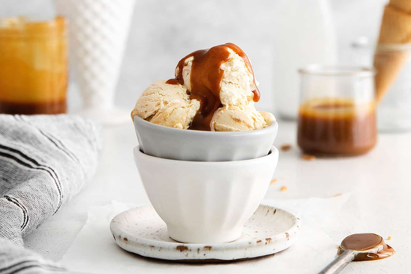 A bowl of ice cream topped with caramel sauced