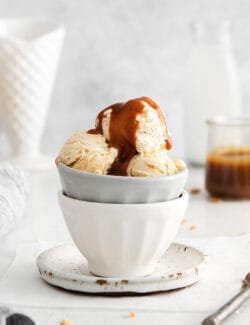 A bowl of ice cream topped with caramel sauce